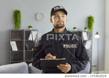 Police officer writing report, investigation of crime or accident, complaint of family violence Police officer writing report, investigation of crime or accident, complaint of family violence 135862628
