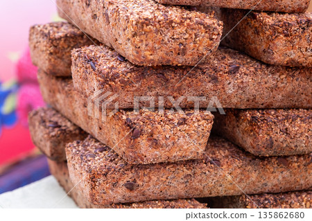 Stacked rectangular whole grain seeded bread loaves 135862680