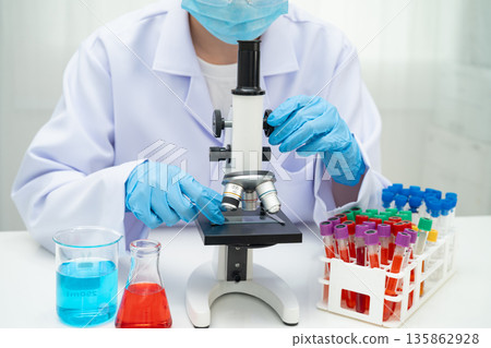 Scientist medical professional use microscope for research in science laboratory. Scientist medical professional use microscope for research in science laboratory. 135862928