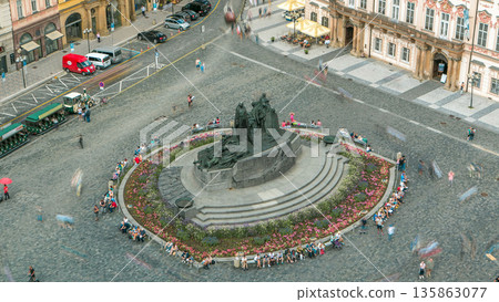 Aerial view of Old Town Square and Jan Hus monument timelapse. People sitting and walking around in Prague, Czech Republic Aerial view of Old Town Square and Jan Hus monument timelapse. People sitting and walking around in Prague, Czech Republic 135863077
