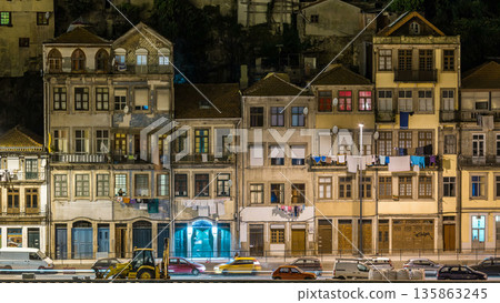 Traditional quaint houses in the old, vintage and touristic ribeira district of Porto at night timelapse, Portugal 135863245
