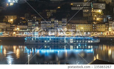 Traditional quaint houses in the old, vintage and touristic ribeira district of Porto at night timelapse, Portugal 135863267