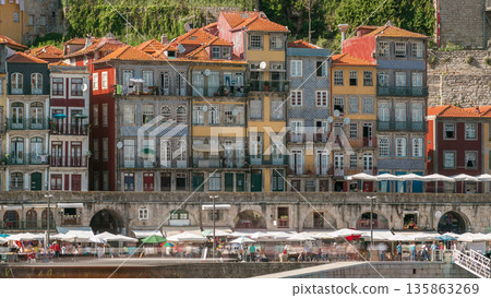 Traditional quaint houses in the old, vintage and touristic ribeira district of Porto at sunny day timelapse, Portugal Traditional quaint houses in the old, vintage and touristic ribeira district of Porto at sunny day timelapse, Portugal 135863269