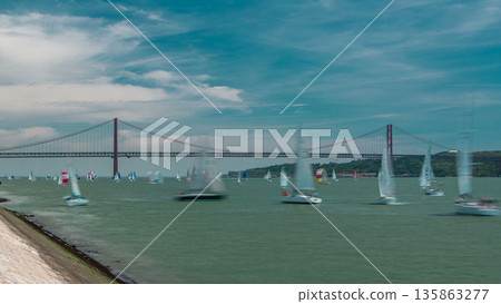 Sailfishes on the Tagus river with 25th of April Suspension Bridge on background timelapse Sailfishes on the Tagus river with 25th of April Suspension Bridge on background timelapse 135863277
