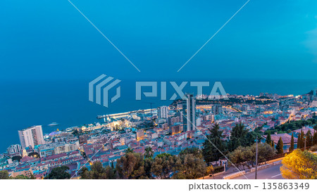 Cityscape of Monte Carlo, Monaco day to night timelapse with roofs of buildings after summer sunset. Cityscape of Monte Carlo, Monaco day to night timelapse with roofs of buildings after summer sunset. 135863349
