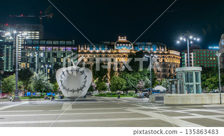 The monumental sculpture The Reintegrated Apple in front of Milan's central railway station night timelapse. The monumental sculpture The Reintegrated Apple in front of Milan's central railway station night timelapse. 135863483