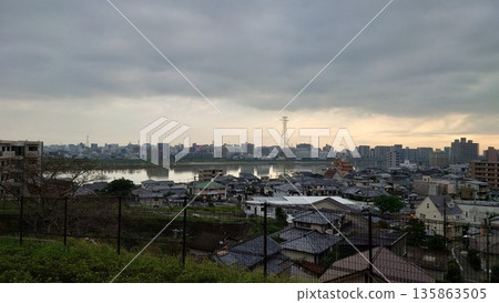 A serene view of the river and cityscape at dusk A serene view of the river and cityscape at dusk 135863505