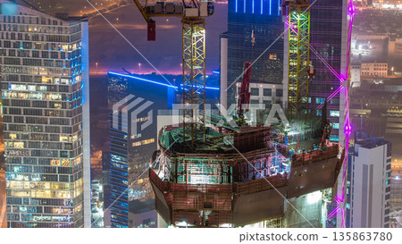 Skyline with Skyscrapers night timelapse in Kuwait City downtown illuminated at dusk. Kuwait City, Middle East 135863780