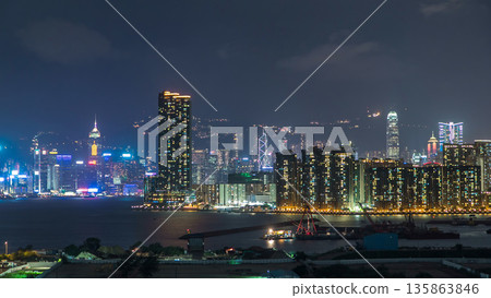 Top view of Hong Kong at night, aerial view from Kowloon bay downtown timelapse Top view of Hong Kong at night, aerial view from Kowloon bay downtown timelapse 135863846