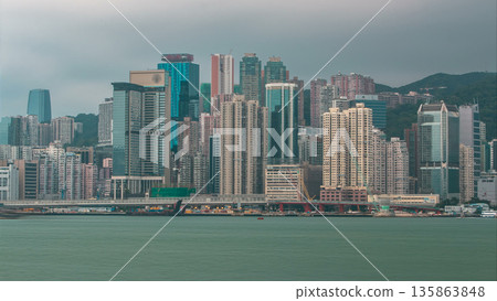 Hong Kong skyline in the morning over Victoria Harbour timelapse. 135863848
