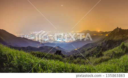 Cityscape of Hong Kong as viewed atop Kowloon Peak night timelapse with Hong kong and Kowloon below 135863863