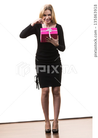 Girl opening pink gift box Girl opening pink gift box 135863918