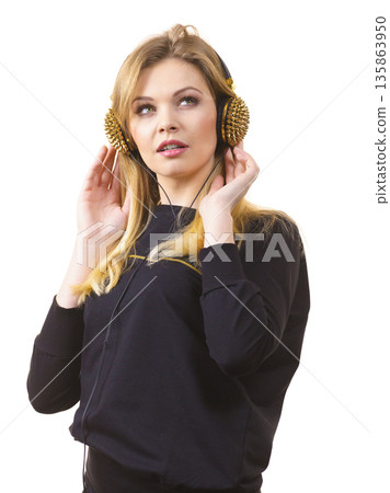 Teenage woman wearing headphones Teenage woman wearing headphones 135863950