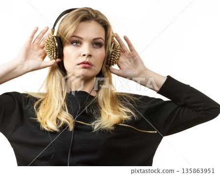 Teenage woman wearing headphones Teenage woman wearing headphones 135863951