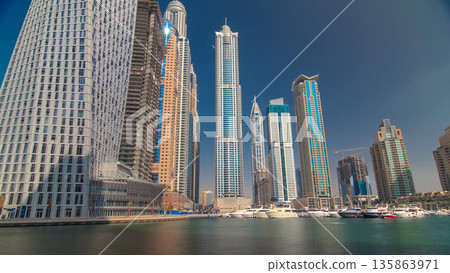 Dubai Marina with tallest skyscrapers and boats timelapse hyperlapse 135863971