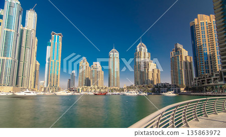 Dubai Marina with tallest skyscrapers and boats timelapse hyperlapse 135863972