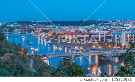 Aerial evening view of the Vltava River and illuminated bridges day to night timelapse, Prague Aerial evening view of the Vltava River and illuminated bridges day to night timelapse, Prague 135863988