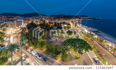 Evening aerial panorama of Nice day to night timelapse, France. Lighted Old Town little streets and waterfront after sunset 135863997