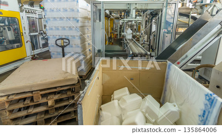 A factory for plastic canister production timelapse hyperlapse. The conveyor in the factory. A factory for plastic canister production timelapse hyperlapse. The conveyor in the factory. 135864006