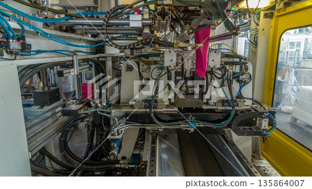 A factory for plastic canister production timelapse hyperlapse. The conveyor in the factory. A factory for plastic canister production timelapse hyperlapse. The conveyor in the factory. 135864007