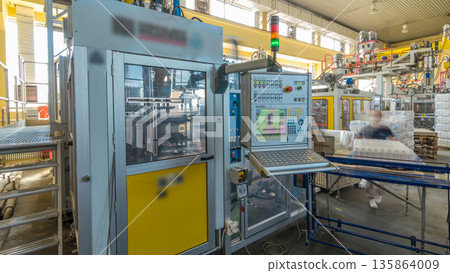 A factory for plastic canister production timelapse hyperlapse. The conveyor in the factory. A factory for plastic canister production timelapse hyperlapse. The conveyor in the factory. 135864009