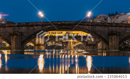Ponte Alla Carraia and Santa Trinita Holy Trinity Bridge day to night timelapse over River Arno in Florence 135864013