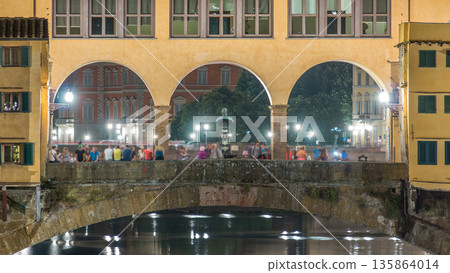 Famous Ponte Vecchio bridge timelapse over the Arno river in Florence, Italy, lit up at night Famous Ponte Vecchio bridge timelapse over the Arno river in Florence, Italy, lit up at night 135864014