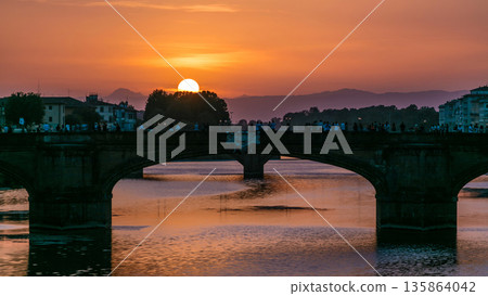 Cityscape view on Arno river with famous Holy Trinity bridge timelapse on the sunset in Florence 135864042