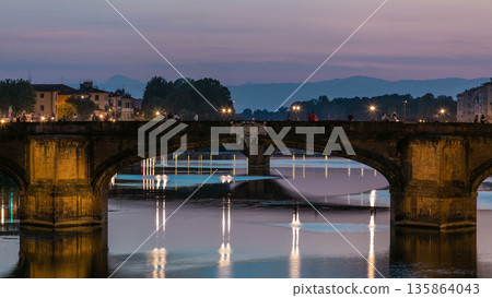 Ponte Santa Trinita Holy Trinity Bridge day to night timelapse over River Arno in Florence 135864043