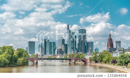 Hyperlapse of Frankfurt's skyscrapers skyline with the bell tower overlooking Alte Brucke. Frankfurt, Germany 135864056