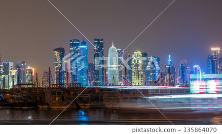 A panoramic view of the old dhow harbour night timelapse in Doha, Qatar, with the West Bay skyline in the background. 135864070