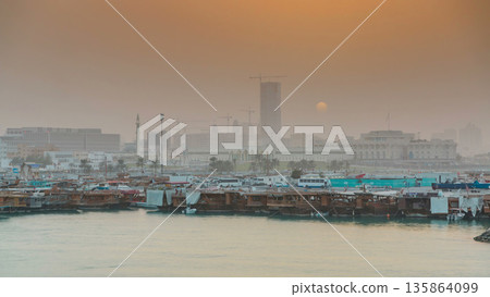 Sunset at Doha Bay timelapse with Traditional Wooden Dhow Fishing Boats. 135864099