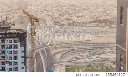 Skyscrapers and road with bridge before sunset timelapse of Doha, Qatar 135864117