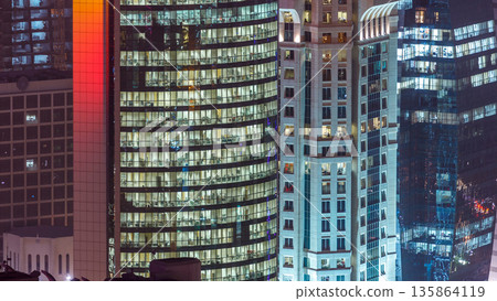 Windows timelapse of the multi-storey building of glass and steel office lighting and working people within Windows timelapse of the multi-storey building of glass and steel office lighting and working people within 135864119