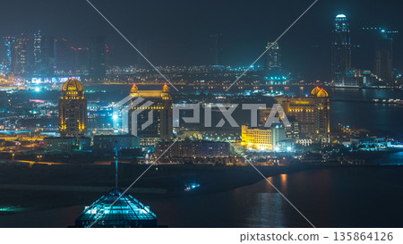 Aerial night view to Pearl-Qatar timelapse from top. 135864126