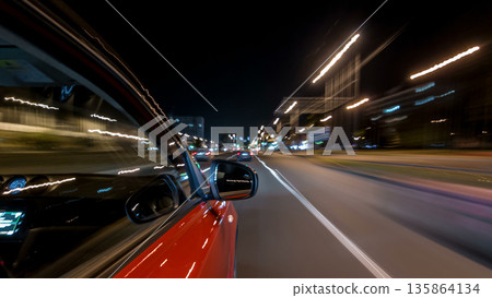 Drivelapse from side of car moving on a night avenue in city timelapse hyperlapse 135864134