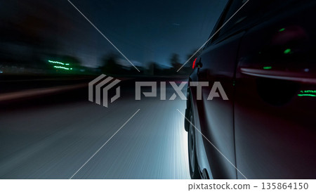 Drivelapse urban look from fast driving car at a night avenue in a city timelapse hyperlapse 135864150