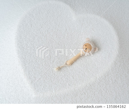 Baby pacifier placed inside heart shape on soft white background. Minimal newborn concept, love, care, parenthood and early childhood symbol 135864162