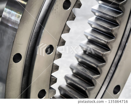 Close-up view of gear mechanism showing teeth and holes in mechanical equipment Close-up view of gear mechanism showing teeth and holes in mechanical equipment 135864716