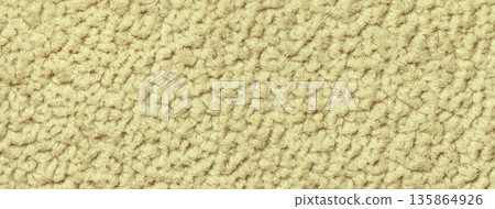 Pastel yellow background from soft fluffy textile with pattern, macro. Texture of light golden plush fabric backdrop 135864926