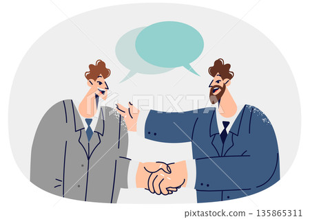 Handshakes of two white collar workers with dialogue clouds entering into partnership agreement 135865311