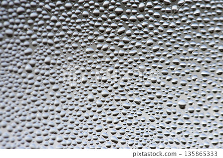 A background of a huge number of water droplets on glass A background of a huge number of water droplets on glass 135865333