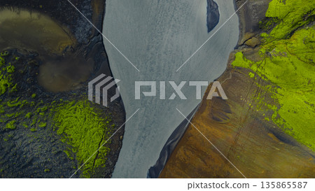 Aerial View of a Winding River Through Iceland's Volcanic Terrain 135865587