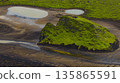 Aerial View of Moss Covered Volcanic Hill and Winding Streams in Iceland 135865591