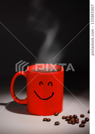 Morning Coffee Cups on the Table With Steam Rising and Coffee Beans Scattered Around 135865807