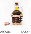 Bottle with olive oil and garlic on a white background 135865842