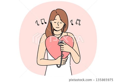 Woman listens to own heart using stethoscope to maintain spiritual harmony and psychological health 135865975
