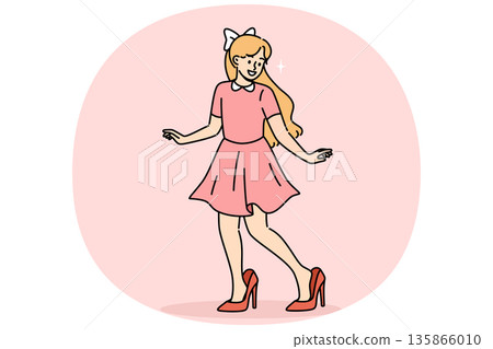 Little fashionista girl tries on mother shoes, imitating mom and wanting to grow up faster 135866010