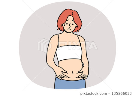 Woman is frightened by appearance of belly fat and afraid of gaining excess weight 135866033