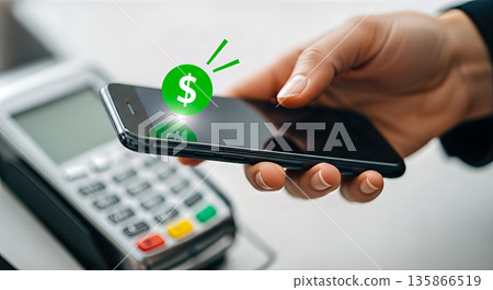 Hand holding mobile phone paying via NFC wireless payment terminal machine POS dollar sign secure transaction banking technology e commerce contactless shopping 135866519